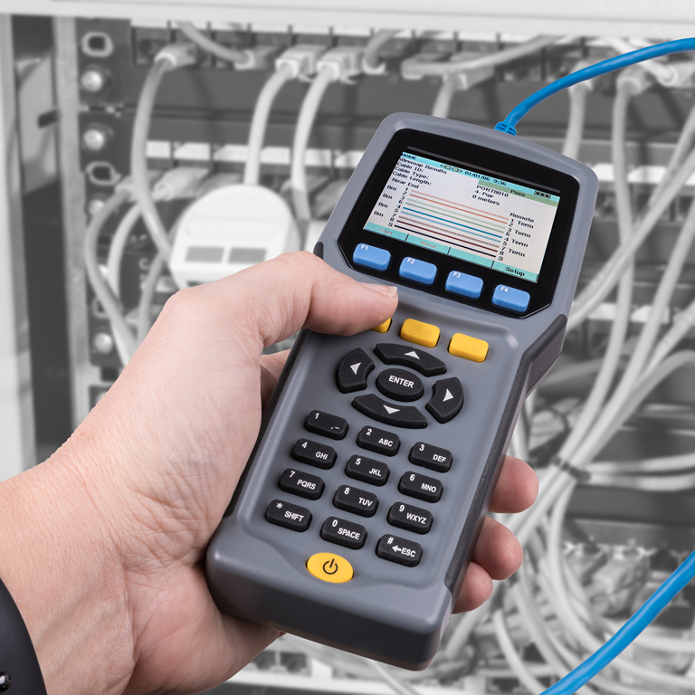 Measurement a cables connected in patch panels of rack case. Detail of male hand when testing structured cabling using a qualified cable performance tester