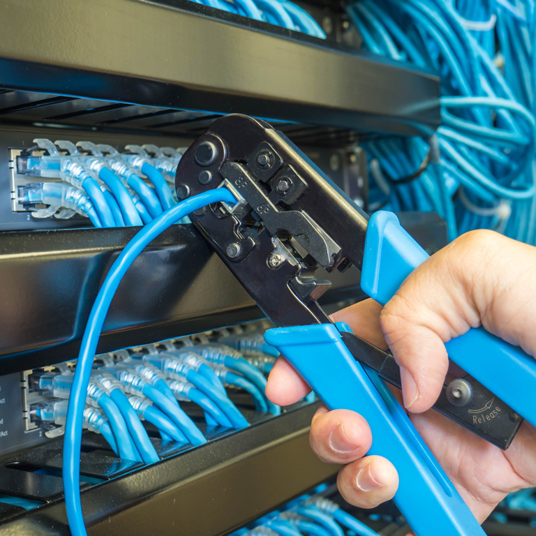 Repair network cable in rack cabinet and hand to crimping pliers tool